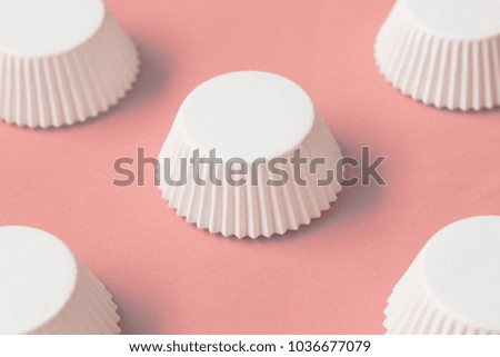 Capsized baking cups on a piece of pastel pink crepe paper