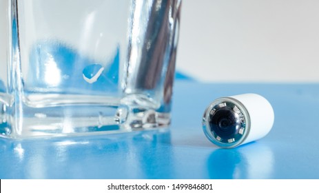 Capsule With Camera For Capsular Endoscopy And Glass Of Water