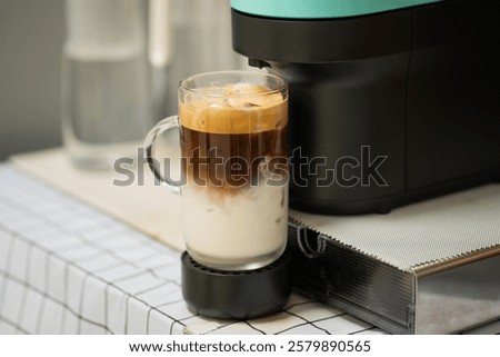 Capsule coffee machine with espresso cup. Nespresso is worldwide leader company with coffe machines and capsules.