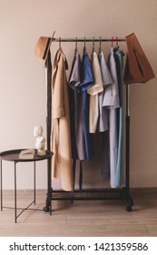 Capsule collection. Clothing on hanger at the modern shop boutique. Bright multi-colored fabrics. Concept of shopping. 