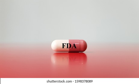 Capsule of medication with FDA letter. FDA or Food and Drug Administration is and agency responsible for control and approve for safety of food and medication.
Medical pharmaceutical concept