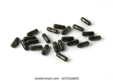 Capsule Of Nigella Sativa ( Black Caraway, Black Cumin, Black Seed ), Herbal Capsules From Habbatussauda Isolated On White Background.