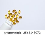 Capsule of omega 3, 6, 9 fish oil, vitamin, food supplement pouring out of medicine bottle on white background 