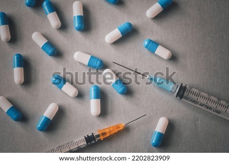 Capsule and syringe background material