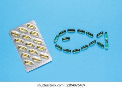 Capsules With Fish Oil On A Blue Background. Biologically Active Additive. Flat Lay.