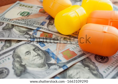 Capsules from kinder surprises on the background of money. The cost of surprises for children. How much is a surprise for children.