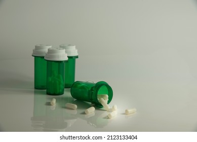 Capsules Spilled Out Of Green Medicine Bottle. 