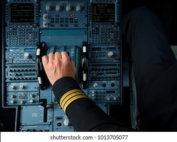 Captain hand accelerating on the throttle in commercial airplane