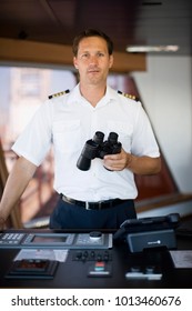 Captain holding binoculars in his hands
