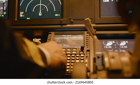 Captain Inserting Destination Coordinates On Cabin Dashboard, Using Control Panel Command To Fly Airplane. Piloting Plane With Engine Throttle, Power Switch And Radar. Close Up.