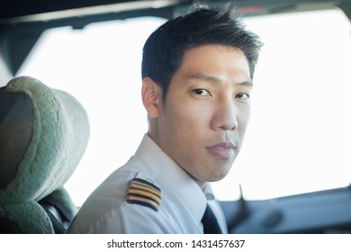 Captain Male Pilot Portrait, Driving An Airplane.