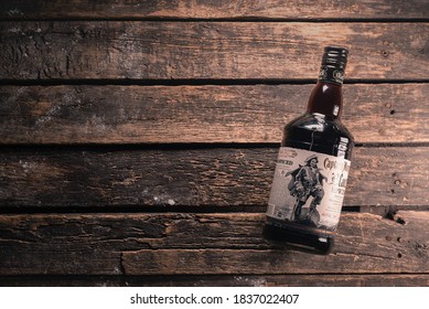 Captain Morgan Rum Black Spiced Bottle On The Wooden Table Background.