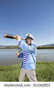 The captain on vacation looking through a telescope into the distance