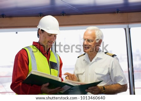 Captain of a ship discussing with a work