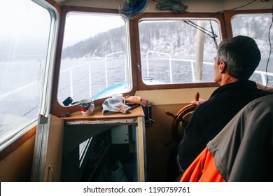 
Captain Of The Ship At The Wheel, In The Cockpit Of The Old Boat