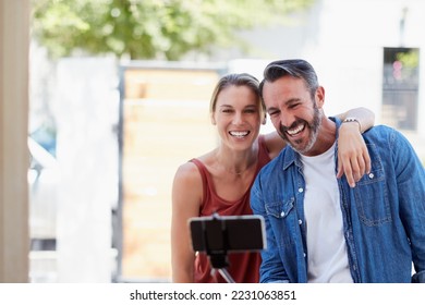 Caption Newlyweds  Cropped shot an affectionate couple taking selfie together and selfie stick outdoors 