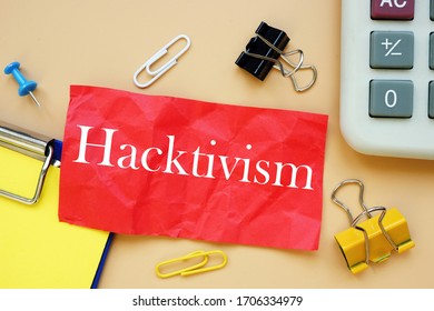 The Caption In The Picture Is Hacktivism. Notebook Sheet, Table, Pens.