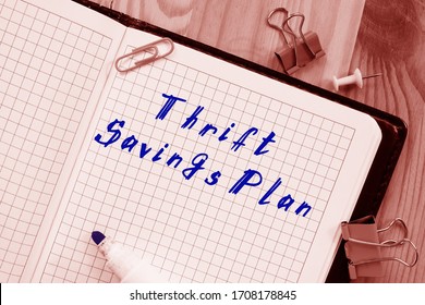 The Caption In The Picture Is Thrift Savings Plan. Notebook Sheet, Table, Pens.