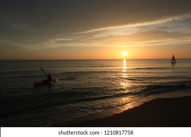 Captiva Island, Florida - 08/05/2015: Kayaker And Sailboat (Sunfish) At Sunset Off The Beach In Captiva Island, Florida.