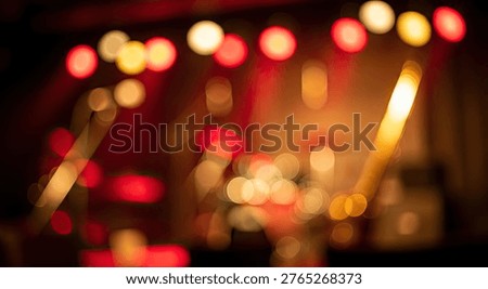 A captivating abstract image featuring out-of-focus stage lights, creating a beautiful bokeh effect with warm red, orange, and yellow hues, perfect for backgrounds and artistic designs.