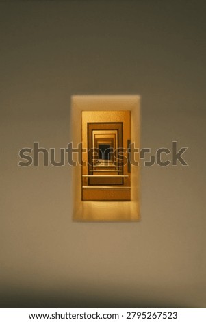 A captivating abstract image featuring a series of receding golden rectangular frames, creating an illusion of an infinite tunnel or portal.