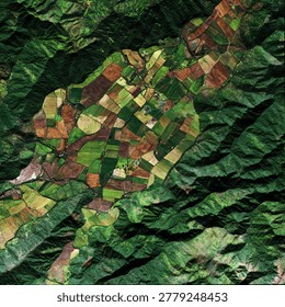 A captivating aerial perspective reveals a patchwork of farmlands nestled amidst the rolling green mountains, showcasing the harmonious blend of agriculture and nature.