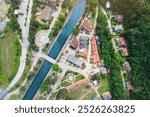 Captivating aerial shot of the traditional town of Ovcar Banja, nestled between mountains and a serene river