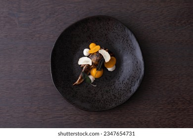 Captivating aerial view of exquisite fine dining cuisine featuring delectable quail dish, perfect for culinary enthusiasts and gourmet connoisseurs.