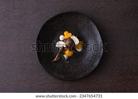 Captivating aerial view of exquisite fine dining cuisine featuring delectable quail dish, perfect for culinary enthusiasts and gourmet connoisseurs.