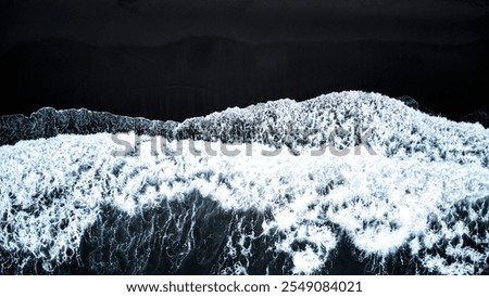 A captivating Aerial View of Waves forcefully Crashing on a stunning Black Sand Beach