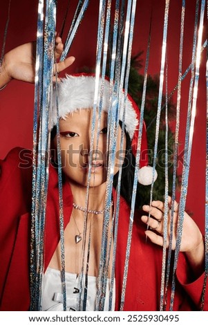 Similar – Image, Stock Photo Woman peeking through Christmas wrapping paper, festive mood
