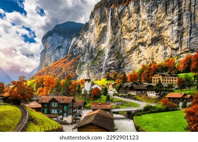 Captivating autumn view of Lauterbrunnen valley with gorgeous Staubbach waterfall and Swiss Alps at sunset time. Lauterbrunnen village with autumn red foliage, Berner Oberland, Switzerland, Europe. - Powered by Shutterstock