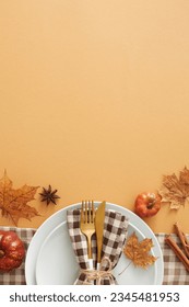 Captivating autumnal decor concept. Top view vertical shot of plate, cutlery, napkin, tablecloth, pumpkins, cinnamon sticks, anise, autumn leaves on pastel brown background with space for ads or text - Shutterstock ID 2345481953