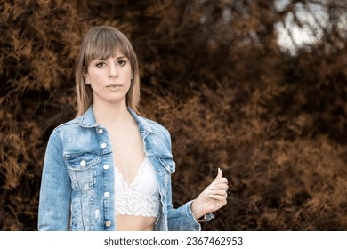 Captivating Elegance: Portrait of a Graceful Woman in Denim Jacket and Lace Bra