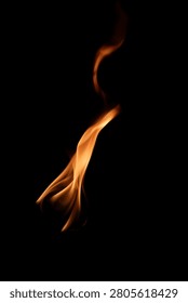 A captivating flame gracefully dances in the darkness, showcasing its elegant curves and warmth. This image captures the essence of energy and movement.