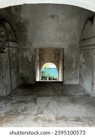 A captivating front-facing view of an ancient gateway in Taman Sari, Yogyakarta. This historical passage once served as a crucial connector between royal areas and surrounding villages. 