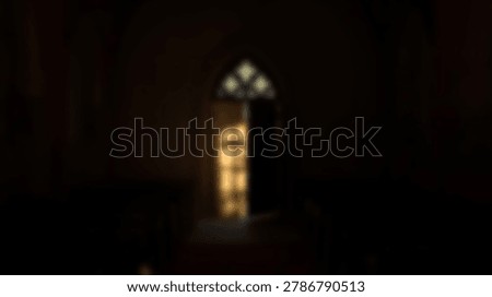A captivating image of a gothic window bathed in light, creating a mysterious atmosphere within a dark room. The windows intricate design is highlighted by the light.