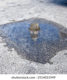 A captivating image of a lighthouse reflected in a puddle, creating a serene scene that blends nature and architecture, showcasing the beauty of light and water.