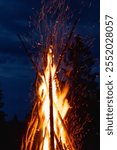 Captivating image of a massive conical bonfire during the Ivan Kupala celebration in the Carpathian mountains, illuminating the night sky