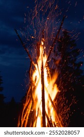 Captivating image of a massive conical bonfire during the Ivan Kupala celebration in the Carpathian mountains, illuminating the night sky