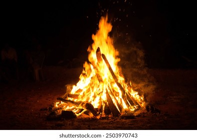 Captivating image of a vibrant bonfire, with flames dancing against the night sky - Powered by Shutterstock