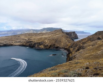 A captivating landscape featuring a rocky coastline, serene blue waters, and a tranquil atmosphere, perfect for relaxation and exploration. A speedboat leaves a white trail in the azure sea. - Powered by Shutterstock