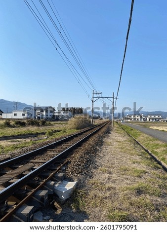 A captivating low angle shot of a railway in a quiet Japanese countryside.