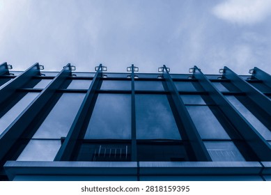 Captivating Low-Angle View of a Sleek Modern Building's Structure and Reflections  