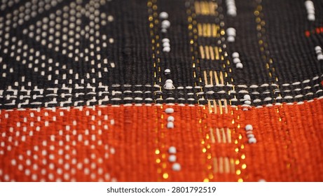 Captivating macro composition of ancient traditional garments showcasing remarkable ethnic craftsmanship and beautiful color tones