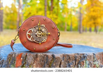 Captivating round bag with a clock face and intricate gears, artfully positioned on a tree stump in the tranquil forest, embodying a perfect blend of fashion and nature.