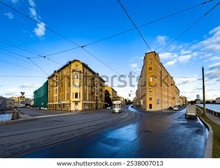 Captivating shot of a tall, triangular corner building bathed in evening light, showcasing Saint Petersburg's architectural charm. Photographed from a low angle to emphasize its unique structure