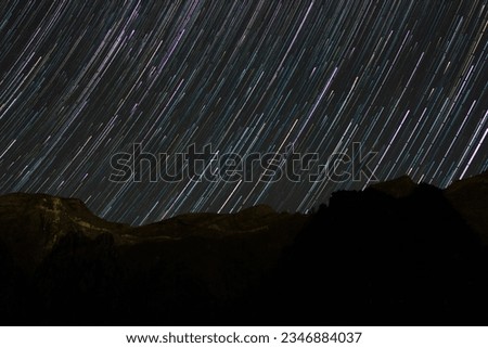 Captivating Star Trail Photography: Mesmerizing celestial trails painted across the night sky. Long exposure astrophotography capturing the beauty of constellations, galaxies, and the cosmos. Serene n
