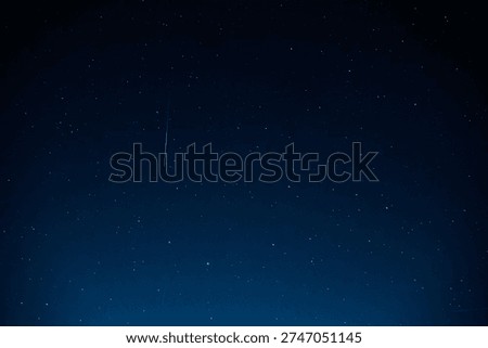 Captivating starry night sky featuring meteor streak among countless stars against deep dark blue cosmic background. Pure astronomy photography showcasing celestial beauty and natural space phenomena
