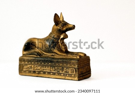 captivating statuette of Anubis, the ancient Egyptian god of the afterlife, depicted as a jackal on a white background